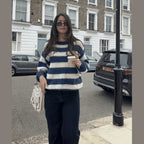 Navy and cream horizontal striped knit sweater with crew neckline