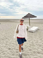 Women's white textured knit sweater with cable-like swirl pattern, long sleeves