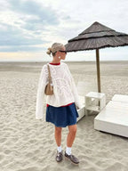 Women's white textured knit sweater with cable-like swirl pattern, round neckline