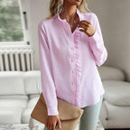 Light pink long-sleeve ruffle button-up blouse with front buttons and ruffled collar