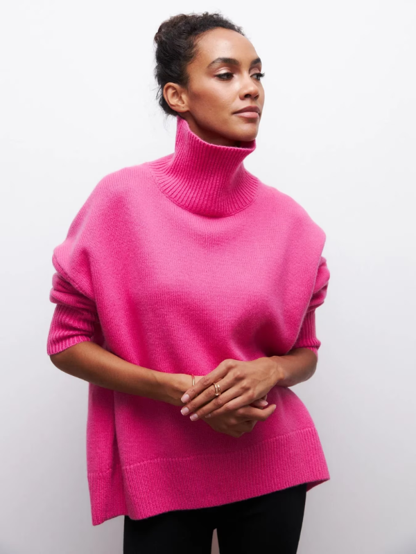 Pink knitted turtleneck sweater with long sleeves and ribbed collar