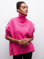 Pink knitted turtleneck sweater with long sleeves and ribbed collar