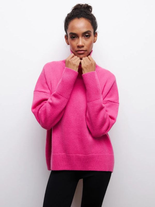 Vivid pink knitted turtleneck sweater with long sleeves and ribbed cuffs