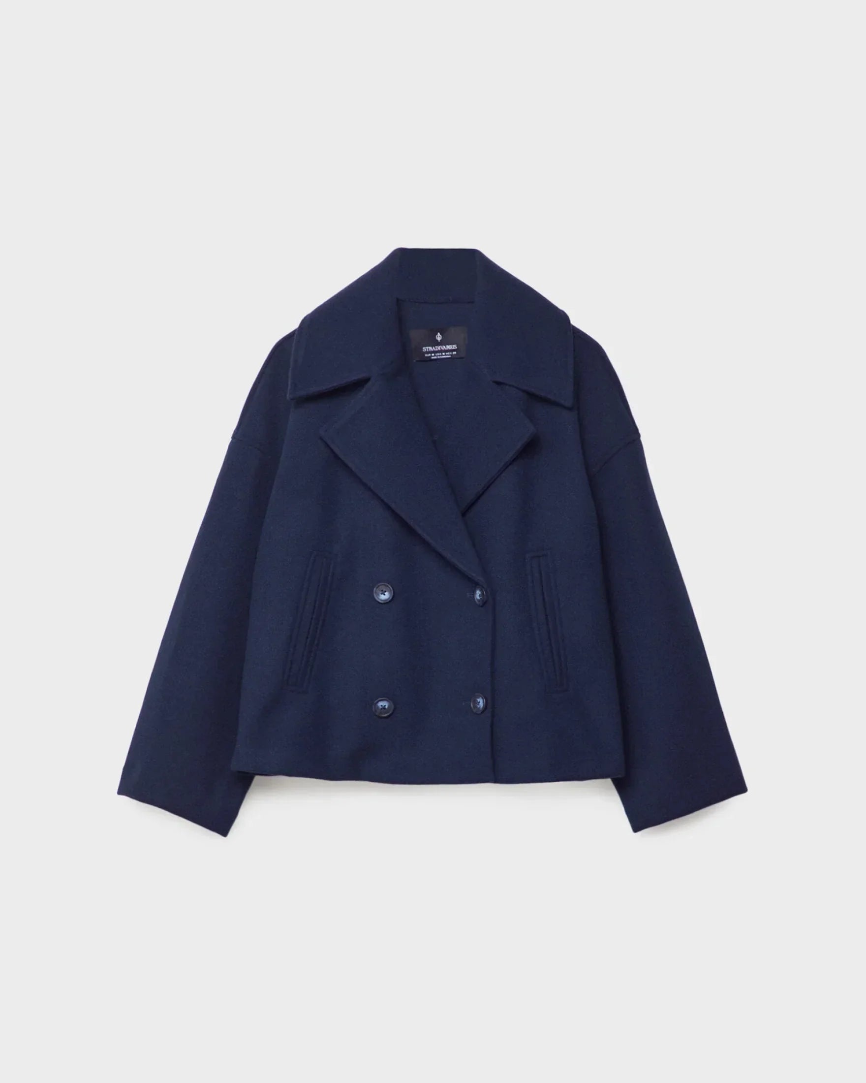 Navy short double-breasted wool jacket, front view with flap pockets and buttons