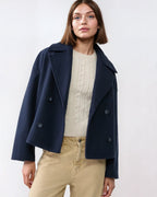 Navy short double-breasted wool jacket with flap pockets and dark buttons