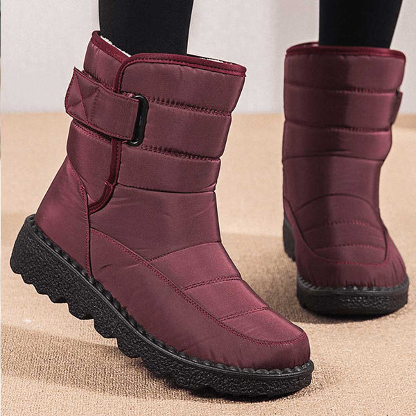 Women's burgundy quilted mid-calf boots with buckle strap and chunky black sole