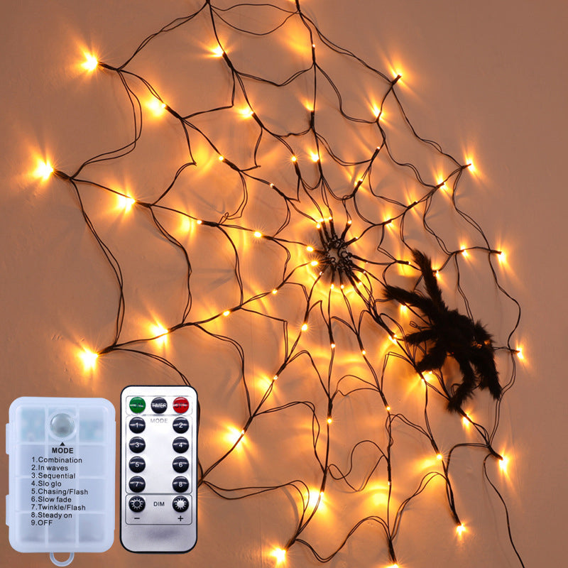 Lit black spiderweb LED lights with a black spider and a remote controller