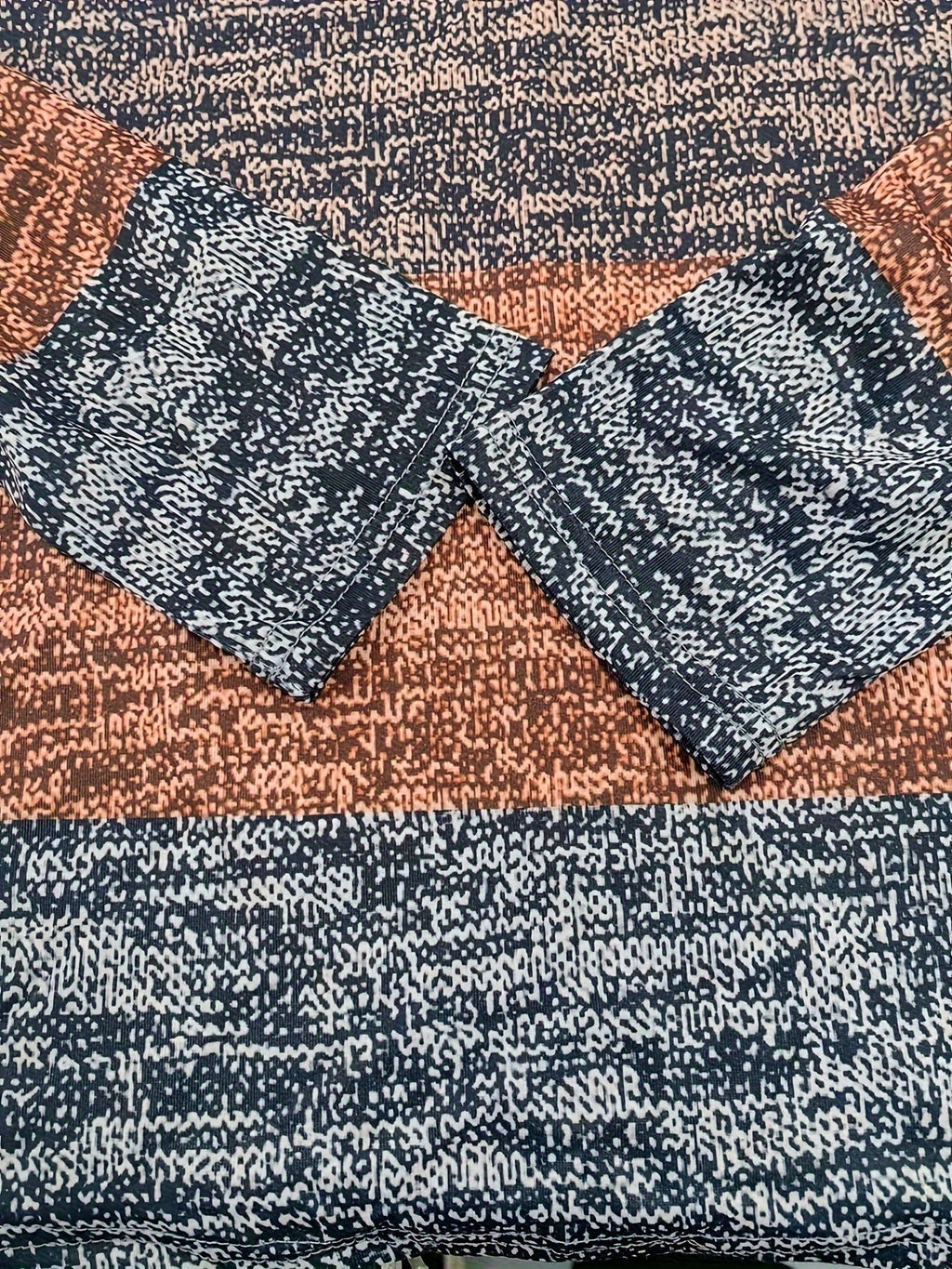 Knit cuff and stripe detail on quarter-zip sweater in charcoal and rust block colors