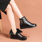 Women’s black ankle boots with side buckle strap and faux fur top lining