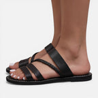 Women’s black leather strap flat sandals with crisscross straps and braided toe detail