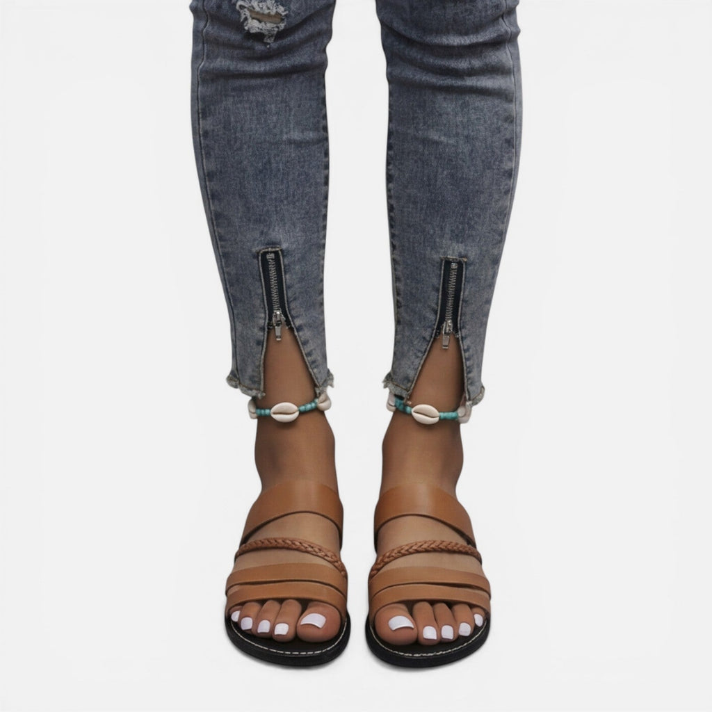 Women’s brown leather strap flat sandals with layered bands and braided toe strap detail