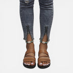 Women’s brown leather strap flat sandals with layered bands and braided toe strap detail