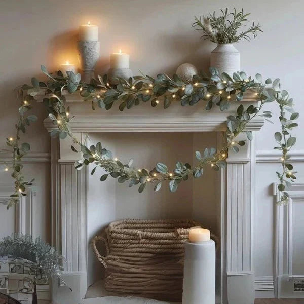 Eucalyptus-style garland with warm twinkling LED lights for fireplace mantel decor