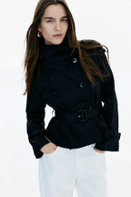 Black trench coat with stand-up collar and tied waist belt, long sleeves