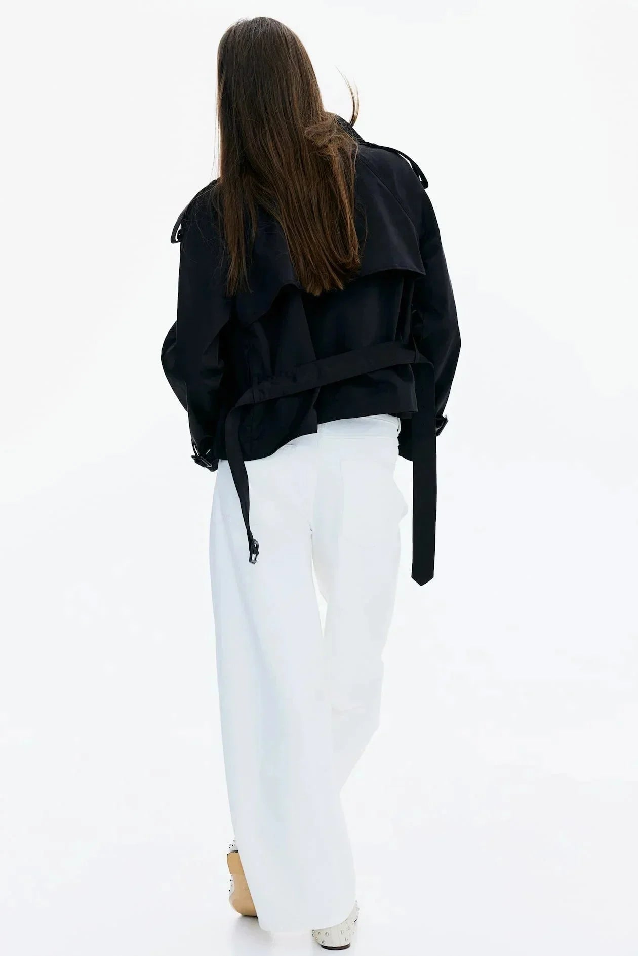 Black trench coat back view with stand-up collar and tied waist belt