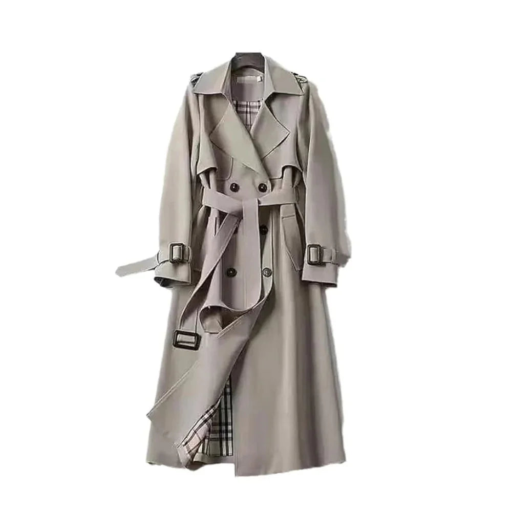 Women’s long trench coat with belt and lapels in light gray, plaid lining visible.