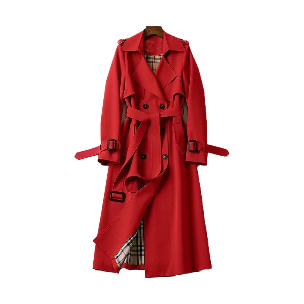 Women’s long trench coat with belt and lapels in red, plaid lining visible.