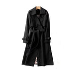 Women’s long trench coat with belt and lapels in black, plaid lining visible.