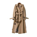 Women’s long trench coat with belt and lapels in light brown, plaid lining visible.