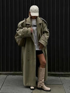 Olive long trench coat with wide lapels and button front, oversized fit