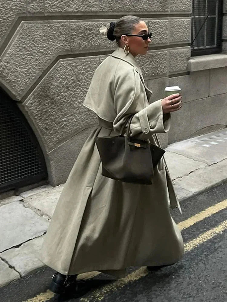 Olive oversized trench coat with wide lapels and belted waist, long length