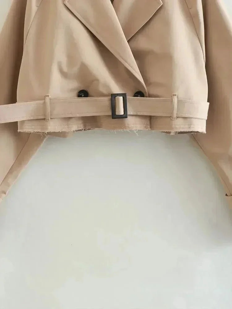 Light-brown trench coat belt with buckle and black button details, front view