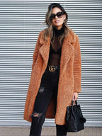 Long teddy coat in warm brown fuzzy fabric, open front with plush collar.