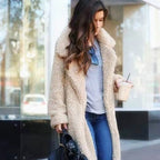 Long teddy coat in cream-beige fuzzy fabric, open front with plush collar.