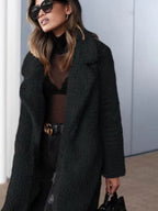 Long teddy coat in dark green-black fuzzy texture, open front with wide collar.