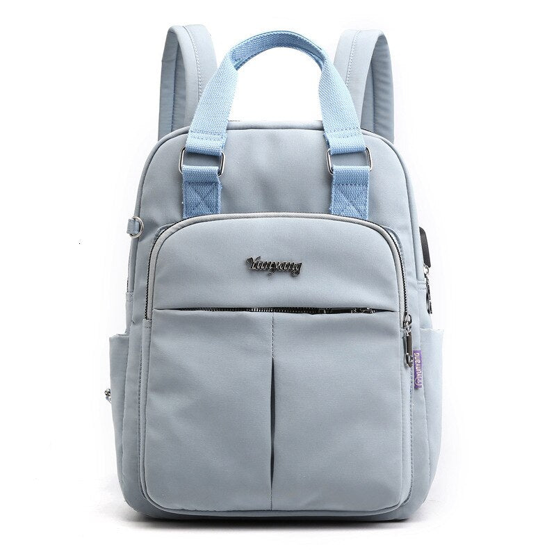Light blue backpack with adjustable straps and front zip pocket panel