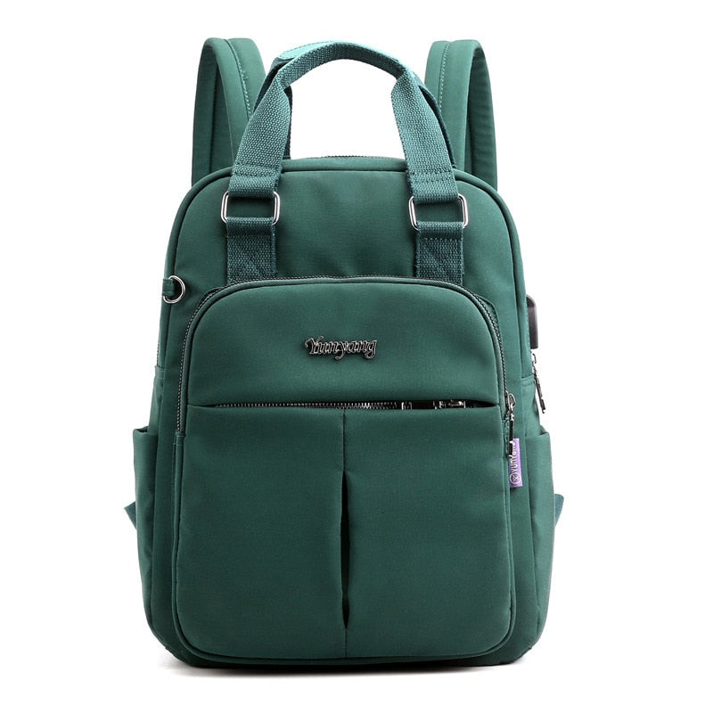 Green water-resistant backpack with padded top handles and front zip pocket, two front sections