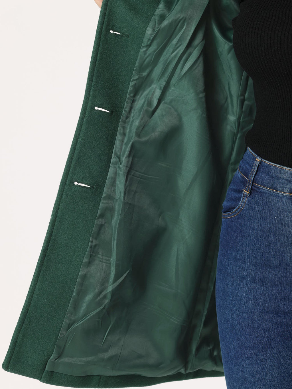 Green coat lining detail with button placket and side slit visible near hem