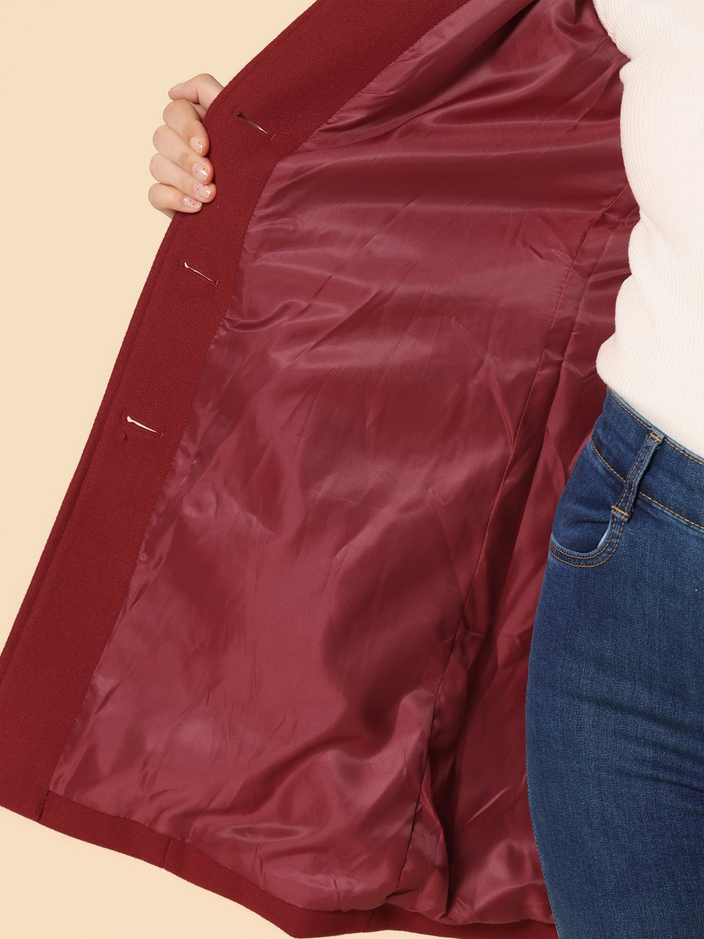Burgundy coat lining detail with button placket and inner fabric texture near side