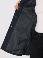 Dark navy single-breasted trench coat lining detail with button placket and seam