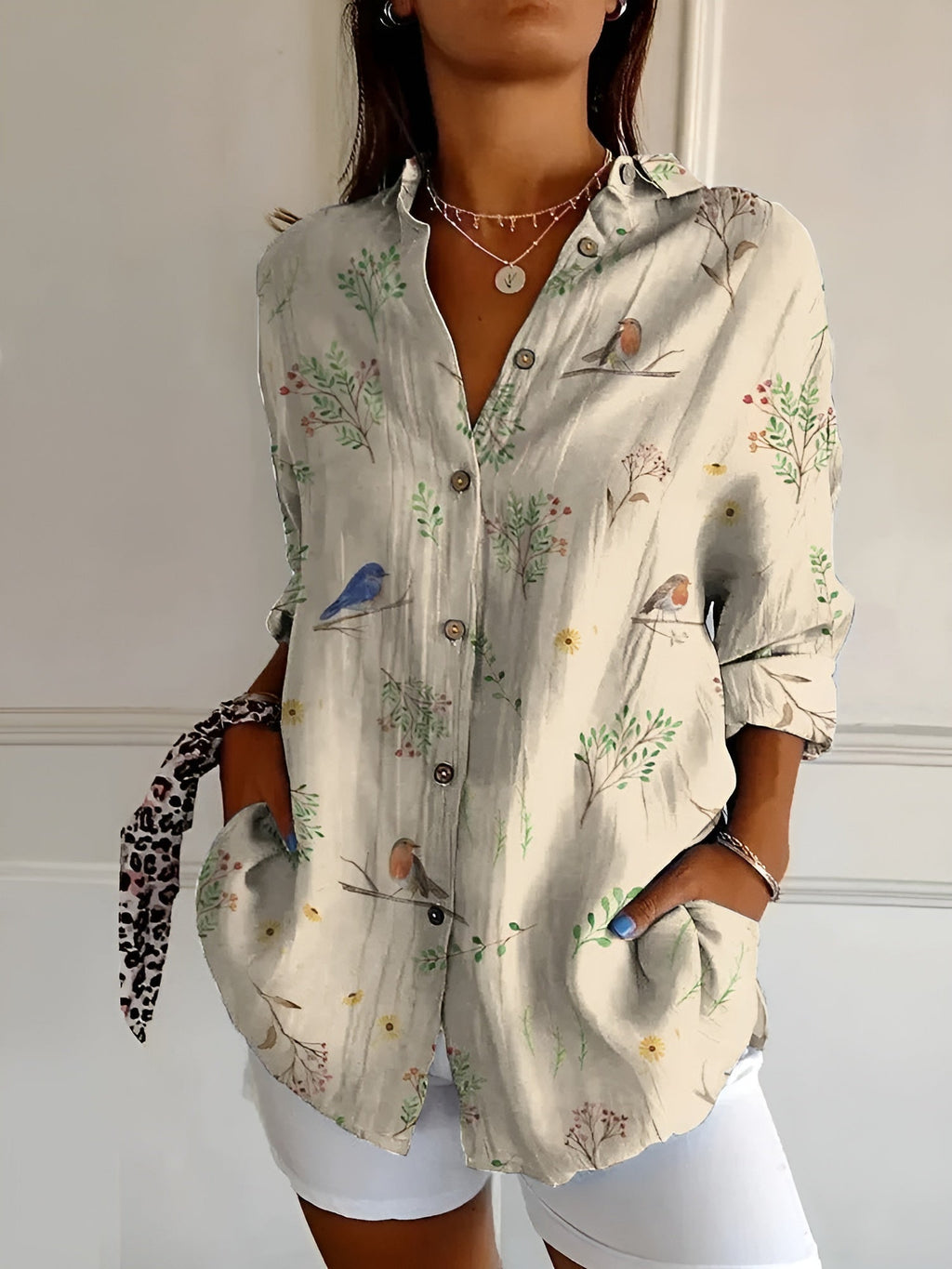 Abstract print split-neck button blouse with long sleeves, light fabric with bird and plant motifs