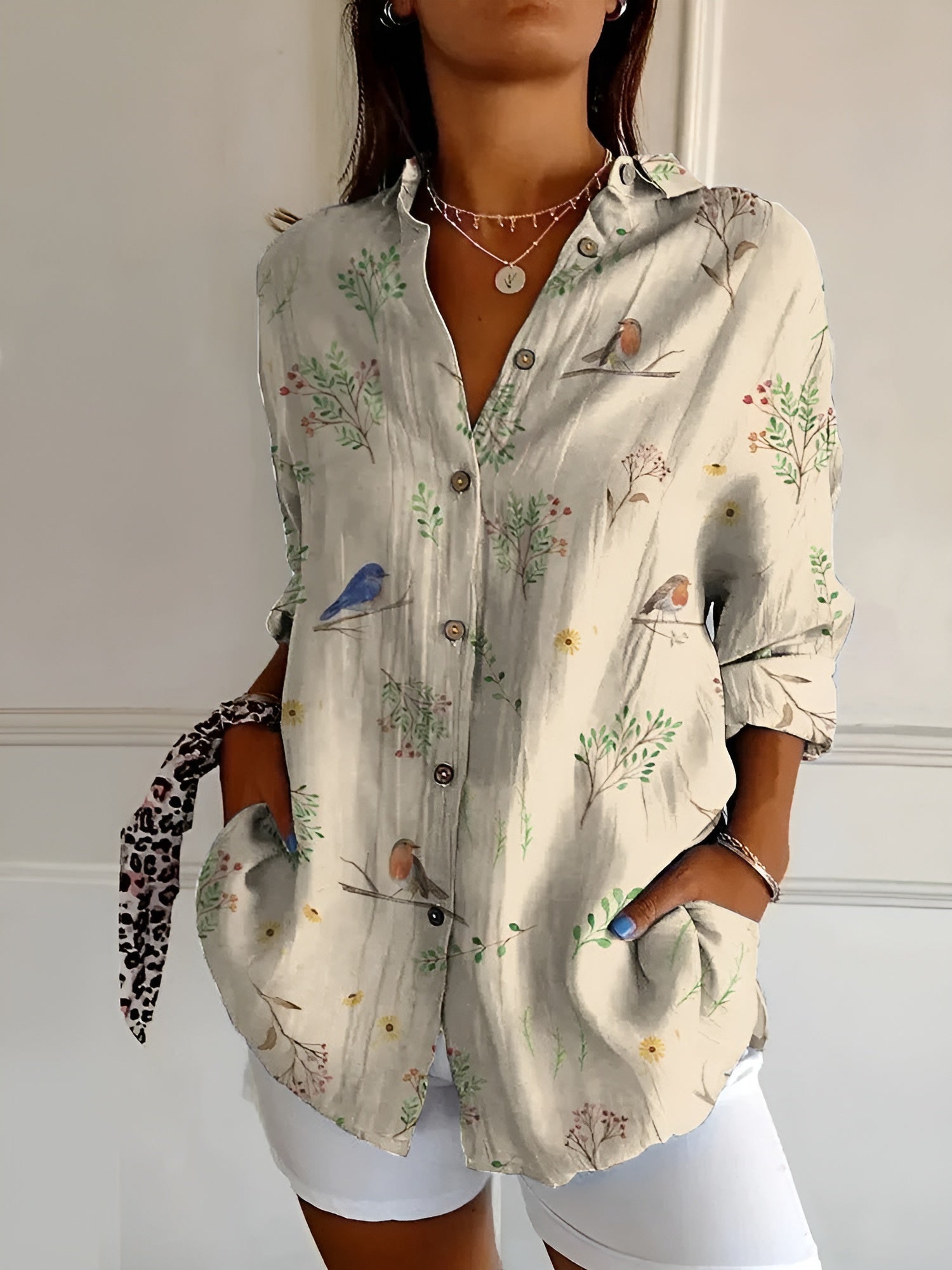 Abstract print split-neck button blouse with long sleeves, light fabric with bird and plant motifs