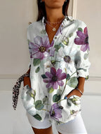 Abstract print split-neck button blouse with long sleeves, white with purple flower motifs