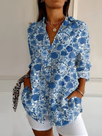 Abstract print split-neck button blouse with long sleeves, blue with white floral pattern