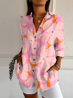 Abstract print split-neck button blouse with long sleeves, pink and orange with graphic shapes