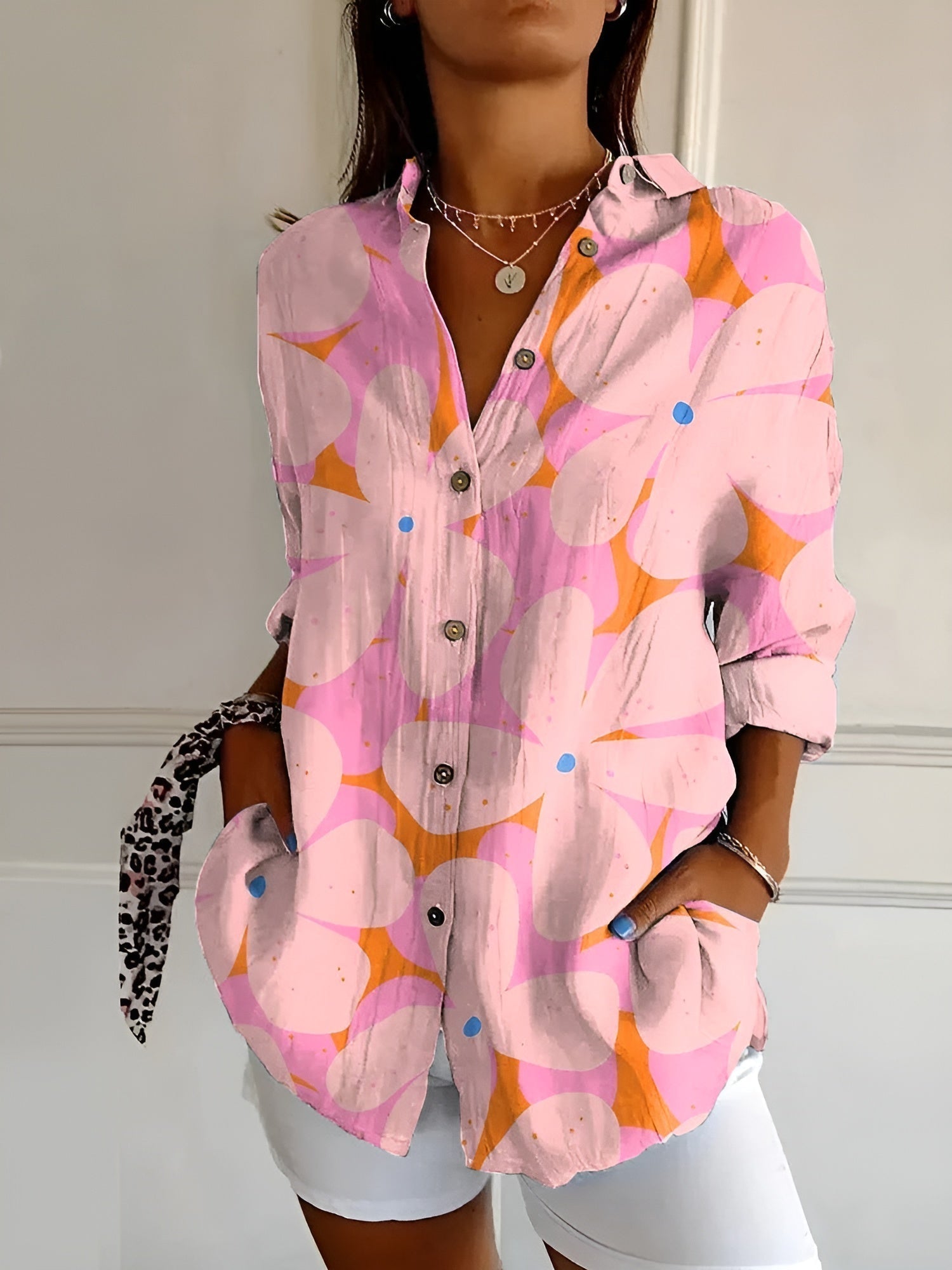 Abstract print split-neck button blouse with long sleeves, pink and orange with graphic shapes