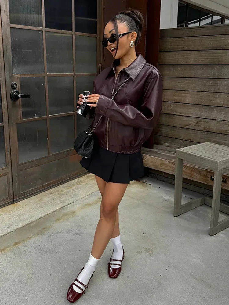 Women’s burgundy faux leather bomber jacket with front zipper and ribbed cuffs