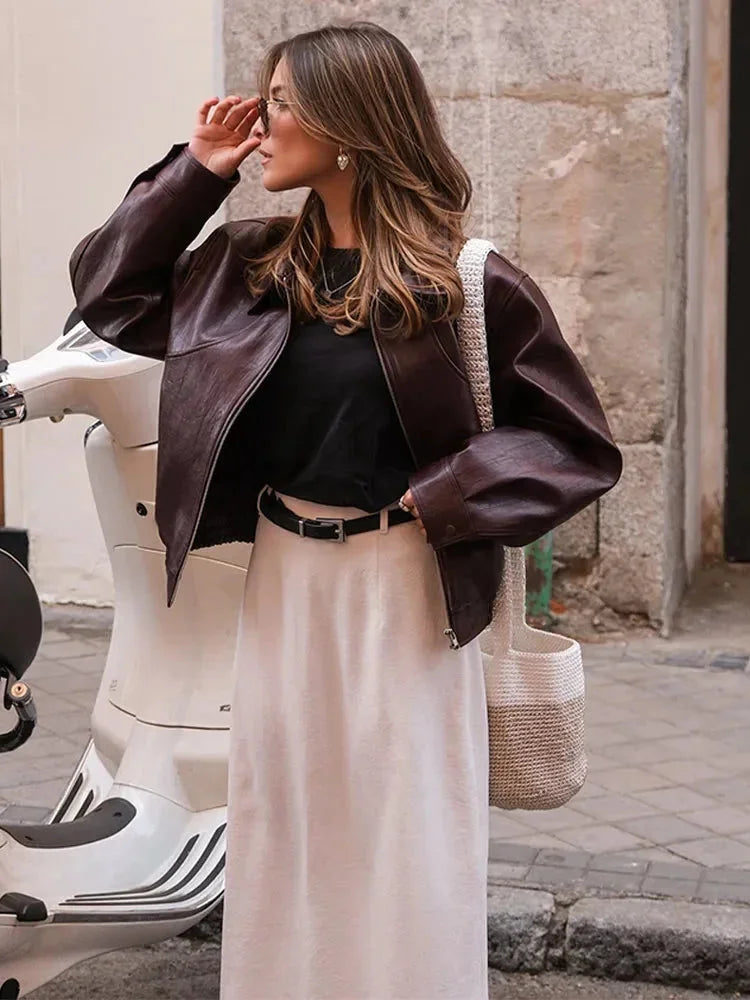Women’s burgundy faux leather bomber jacket with stand collar and zip front, ribbed cuffs