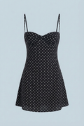 Black polka dot mini dress with structured bust and thin spaghetti straps