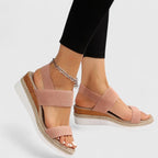 Peach-pink two-strap platform sandals with open toe and gold chain ankle detail