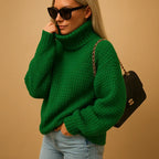 Women’s thick knit turtleneck sweater, green chunky texture, long sleeves.