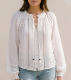 White lace-trim blouse with V-neck and long puff sleeves, vertical pintuck stripes, buttons