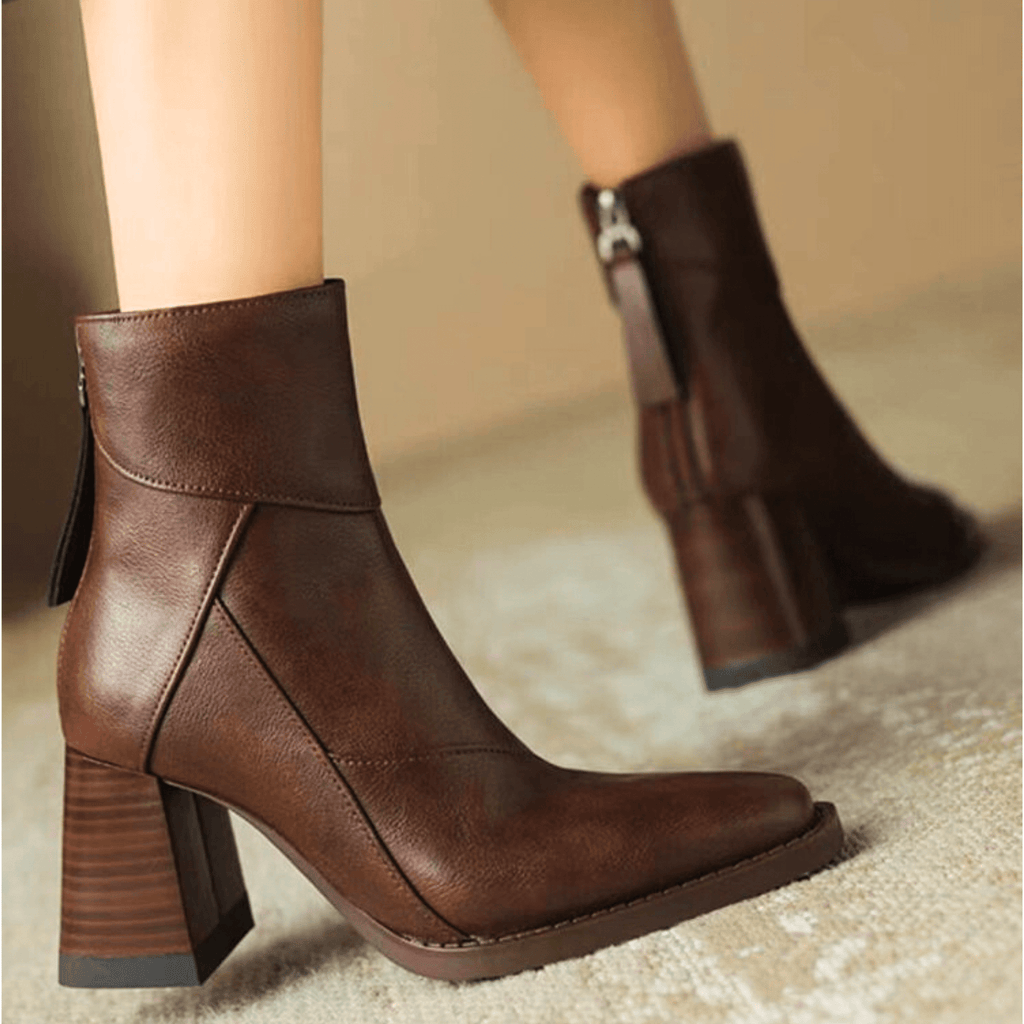 Brown ankle boots with block heel, side pull tab, and low-profile stitched toe panel