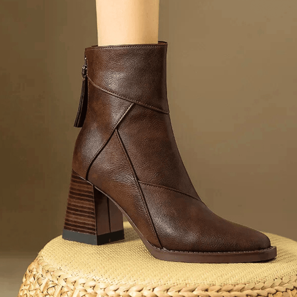 Brown ankle boots with block heel, side zipper, and stitched V-panel detail