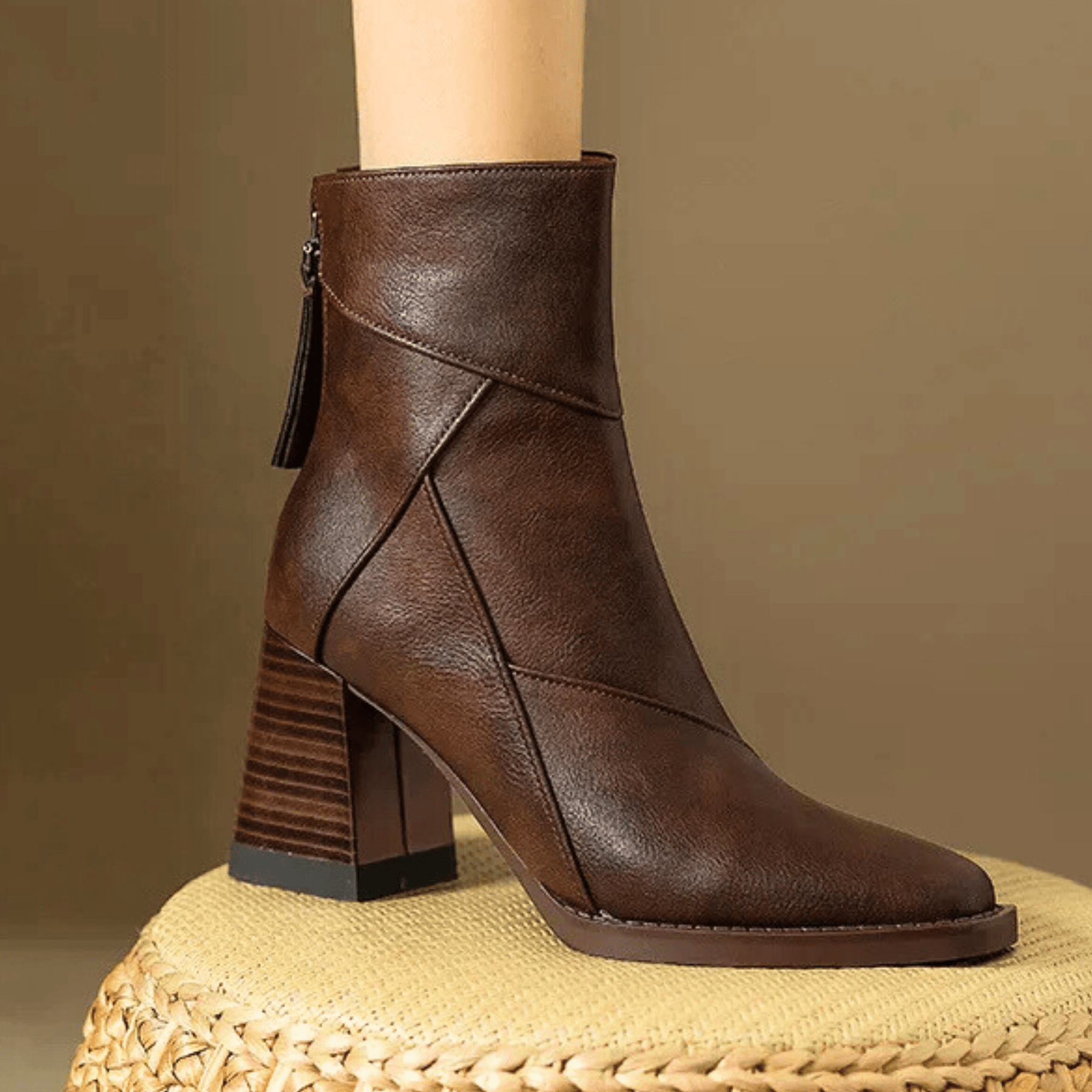 Brown ankle boots with block heel, side zipper, and stitched V-panel detail
