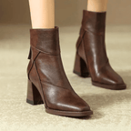 Pair of brown ankle-fit block heel boots with pointed toe and side zipper